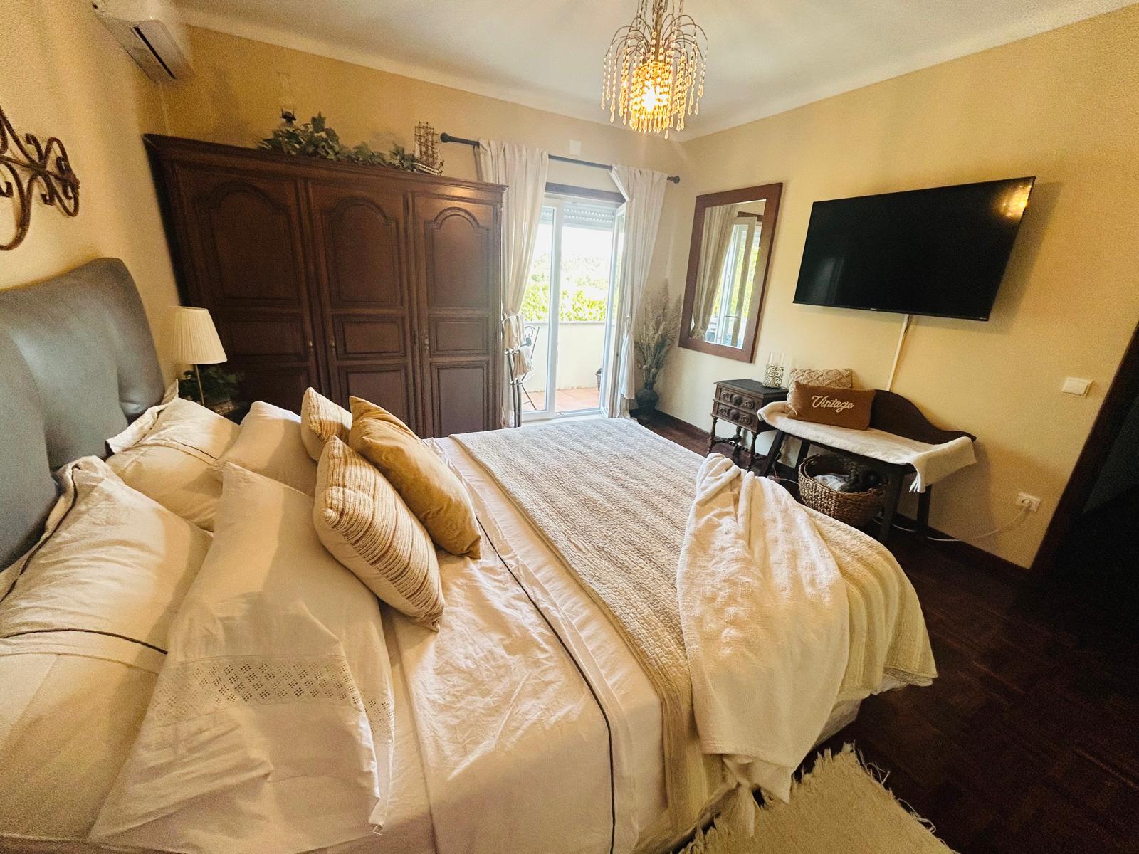 The Orchard Lookout — queen bed with TV and antique armoire
