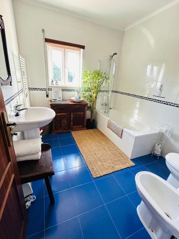 The Orchard Lookout — bathroom with blue tile floor and wooden vanity