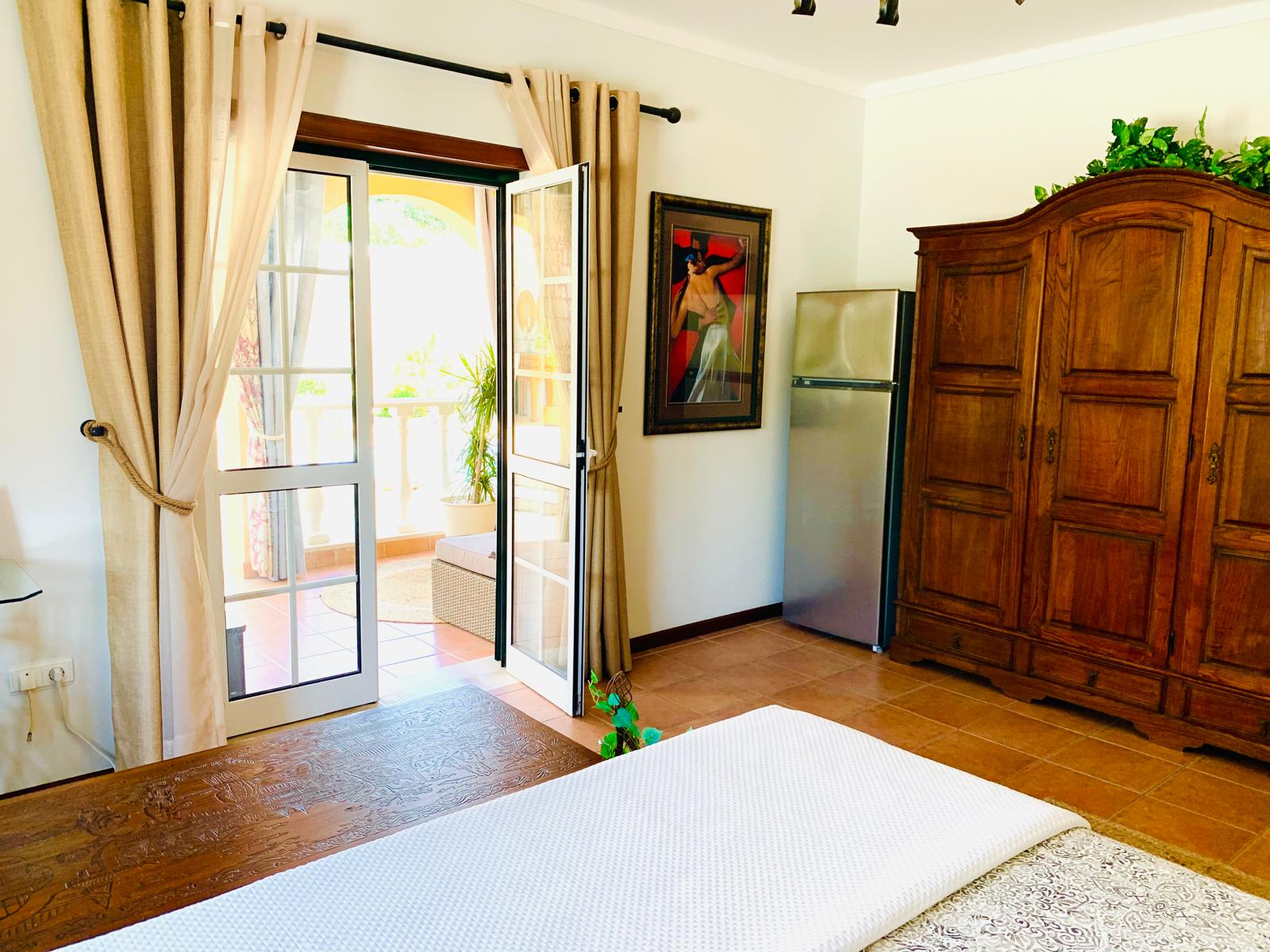 French doors open from the Rose Parlor to a sunlit private porch