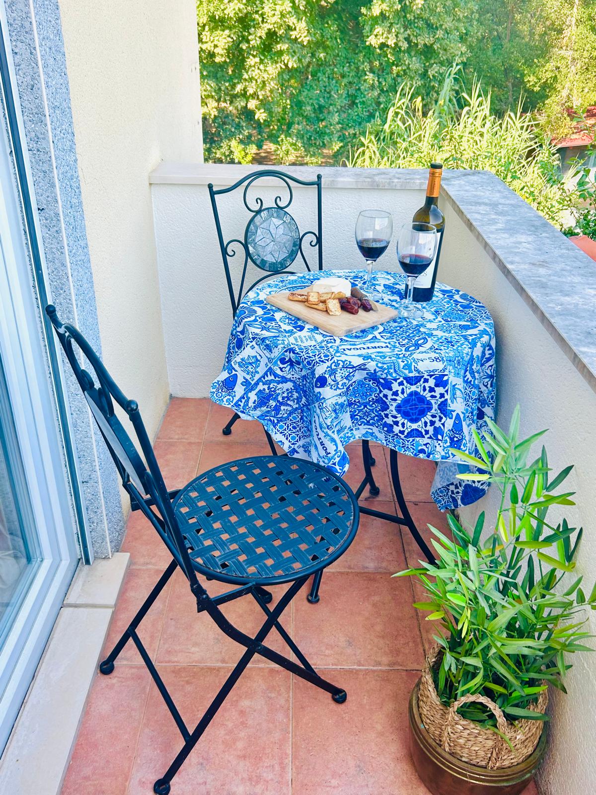The Orchard Lookout — private balcony bistro seating with wine and cheese