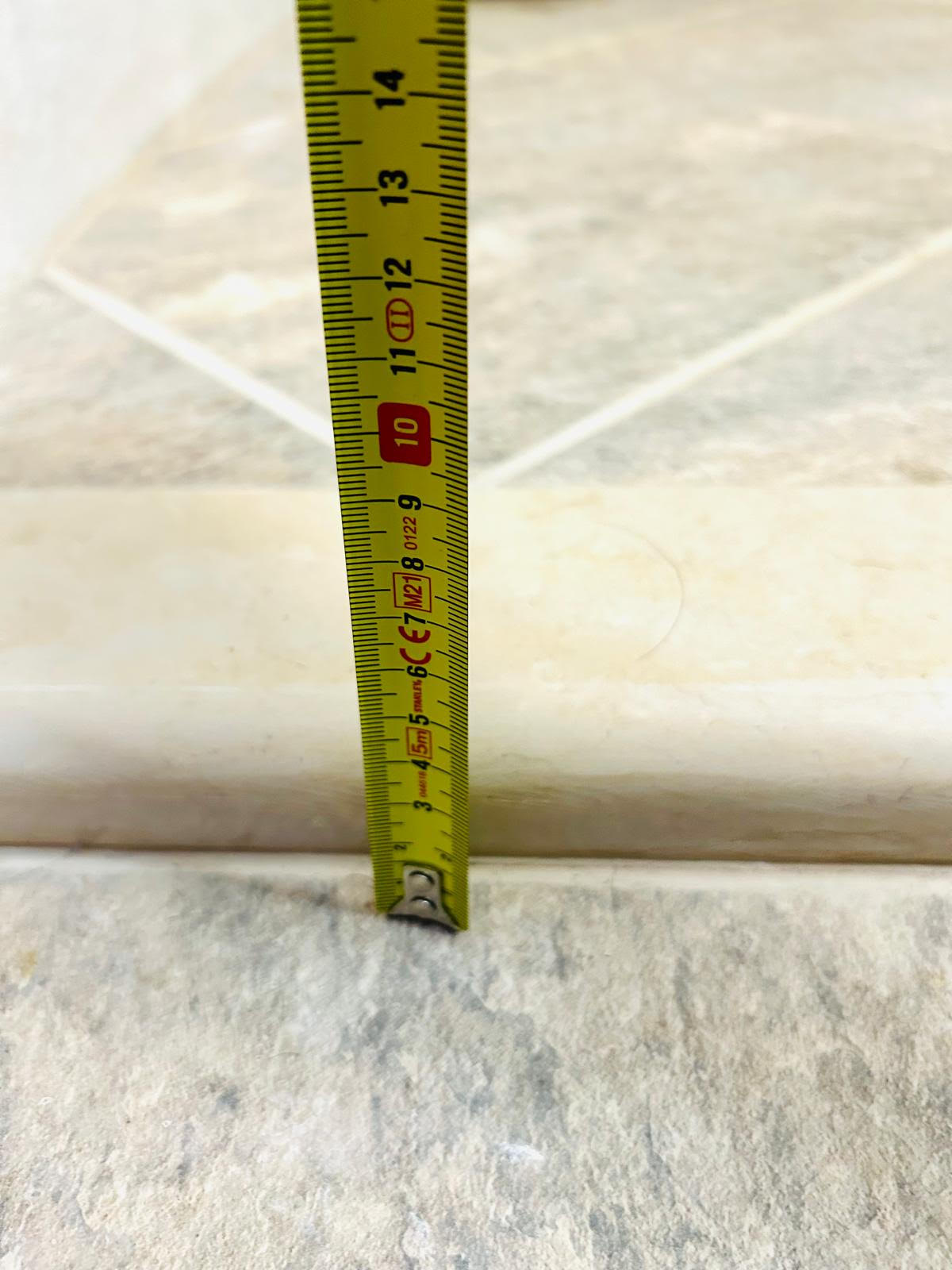 Tape measure showing the 1-inch (2.5 cm) threshold at the front door