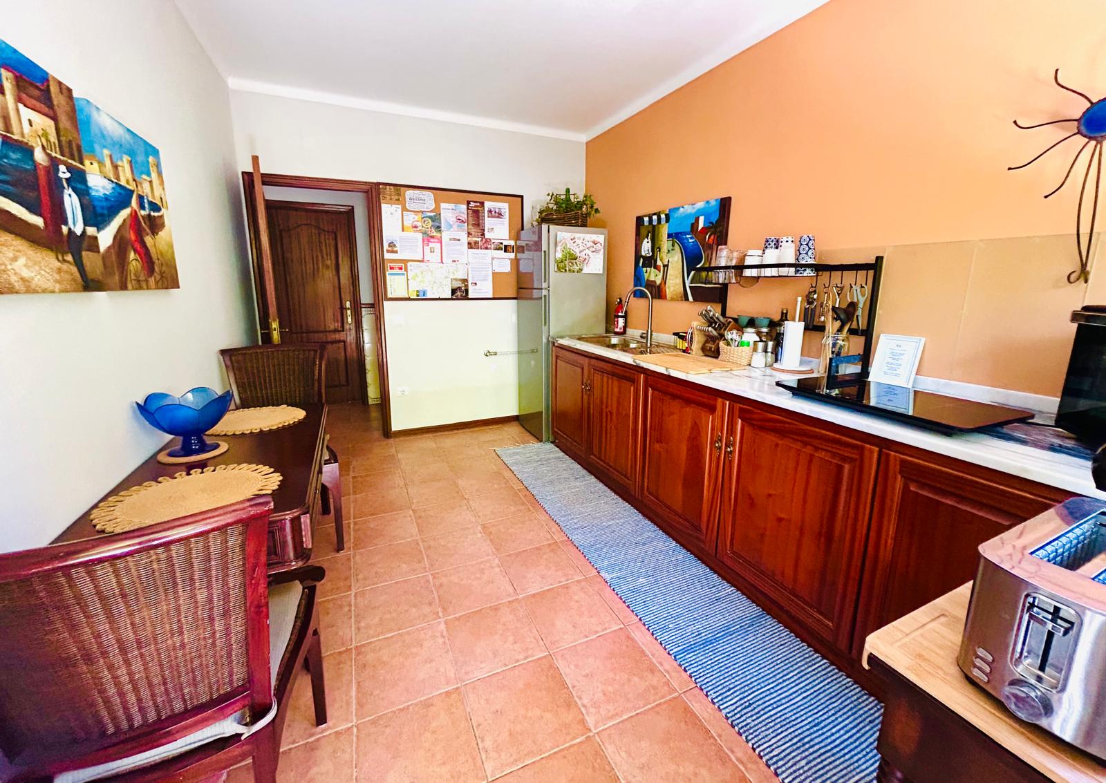 Kitchenette dining nook and local information board at Sunrise Villa Alvorada