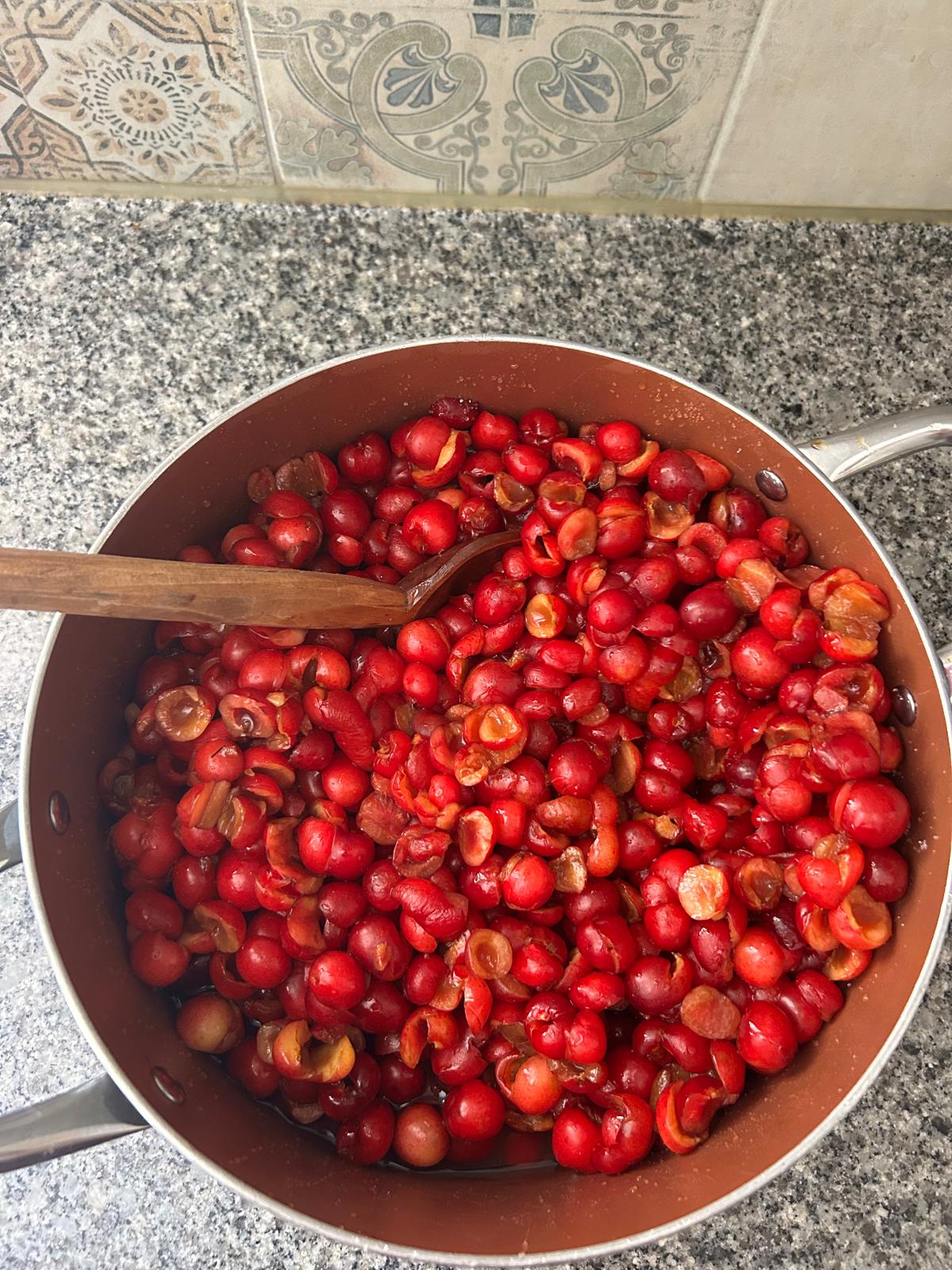 Big pot of pitted cherries ready for jam or preserves