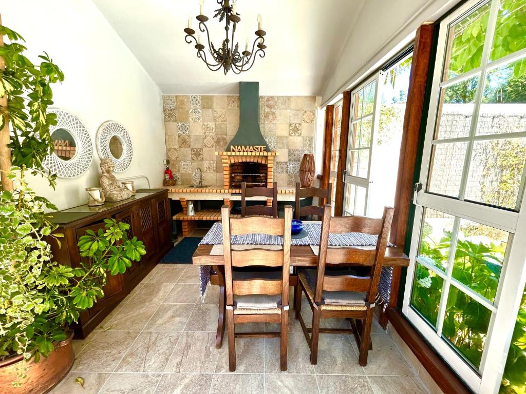 Open-plan kitchen with wood-burning stove at Sunrise Villa Alvorada